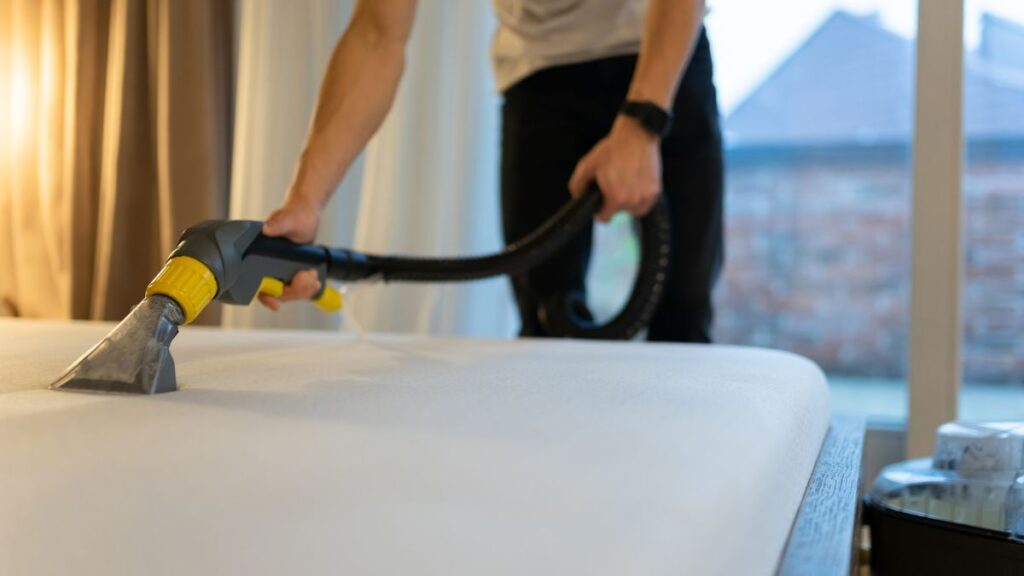 Man steam clean a mattress