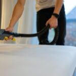 Man steam clean a mattress